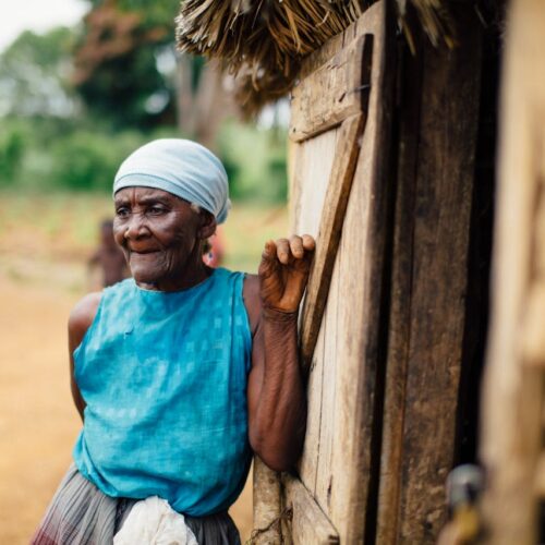 Photo of an old lady standing by in Haiti Latam