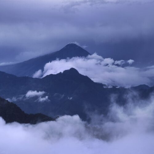 Image of vulcano between clouds blue